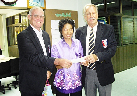 Tony and William present a donation from the Pattaya Sports Club to Kak, who runs the centre.